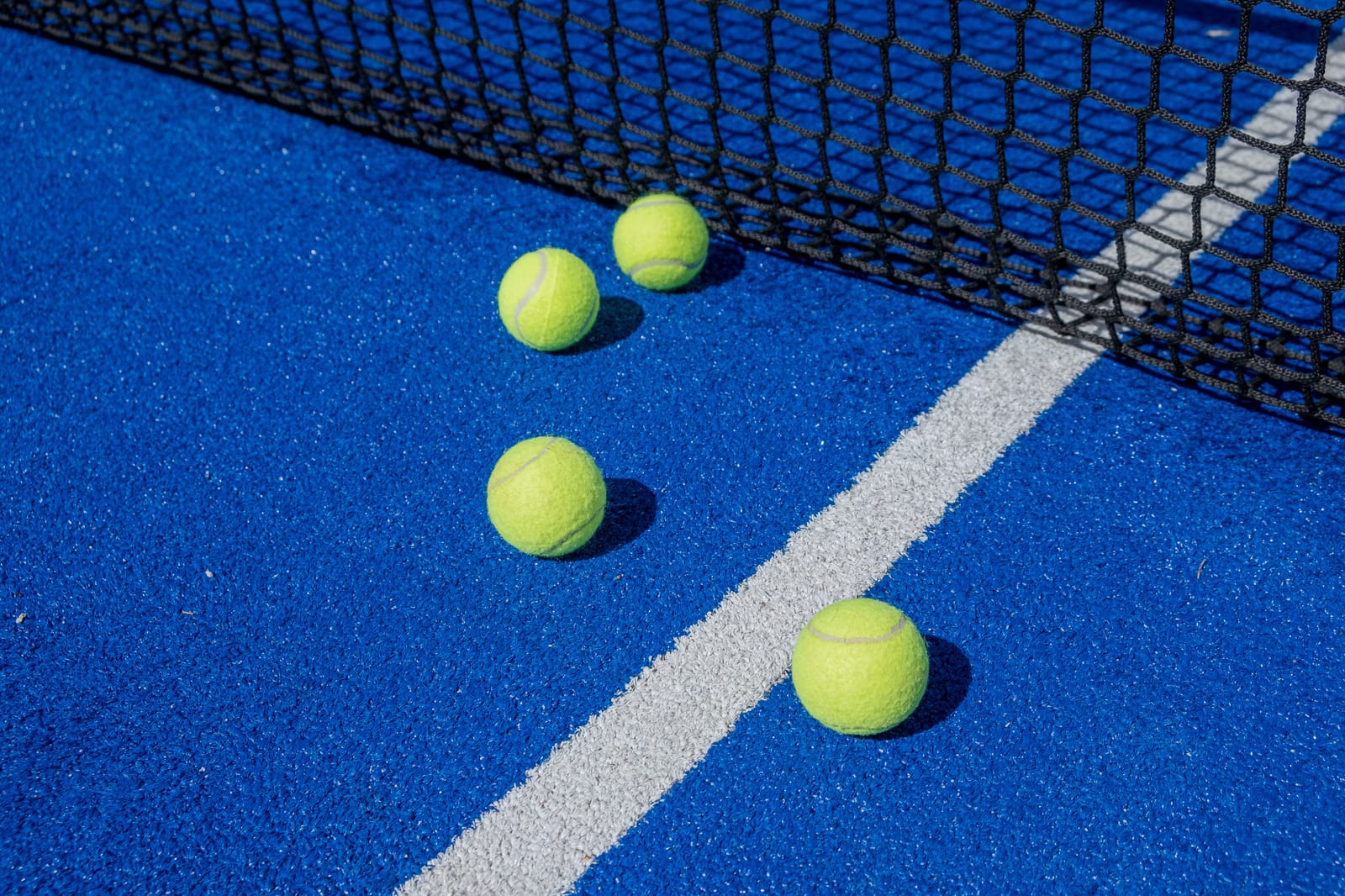 Palline da padel sul campo blu